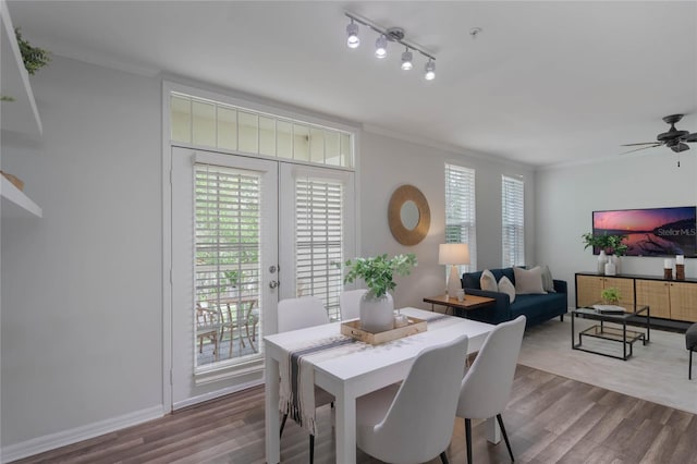 dining area with hardwood / wood-style floors, ceiling fan, and ornamental molding