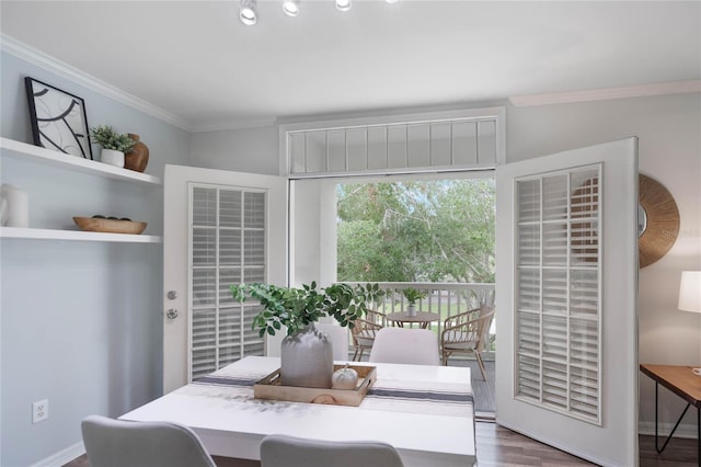 dining area with hardwood / wood-style flooring and ornamental molding