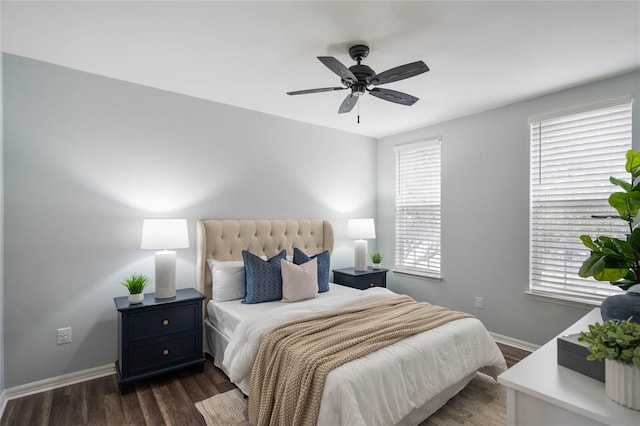 bedroom with multiple windows, ceiling fan, and dark wood-type flooring