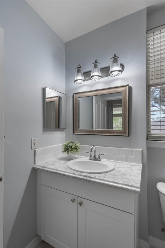 bathroom with vanity and toilet