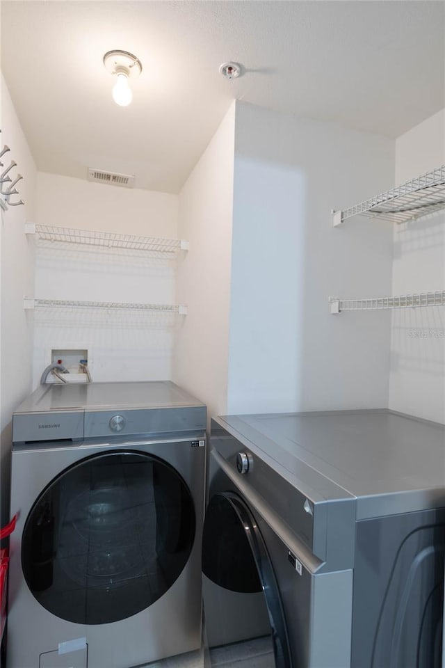 laundry room featuring independent washer and dryer