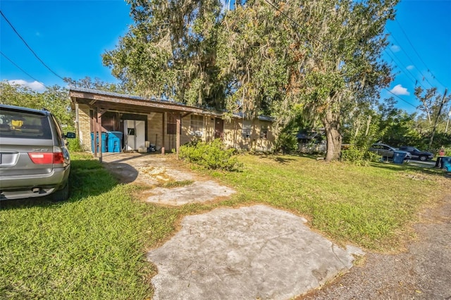 bungalow featuring a front yard and a carport