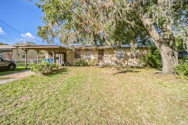 ranch-style house with a front lawn and a carport