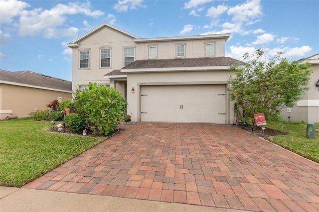 front facade with a garage and a front lawn