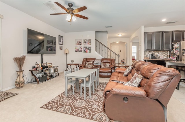 carpeted living room featuring ceiling fan