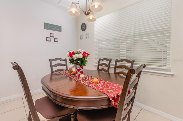 tiled dining room featuring a notable chandelier