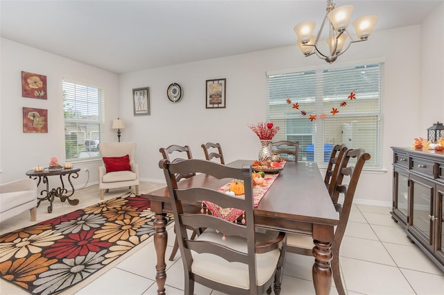 dining room with a chandelier and light tile patterned flooring