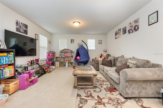 living room featuring light colored carpet and a healthy amount of sunlight