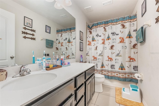 bathroom featuring tile patterned floors, vanity, toilet, and walk in shower