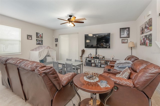 carpeted living room with ceiling fan