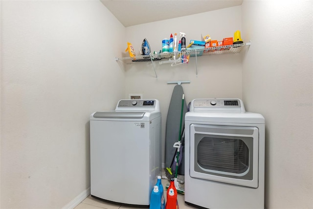 laundry room with light tile patterned floors and washer and dryer