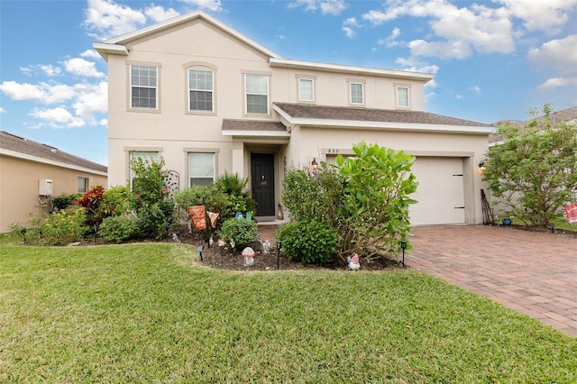 view of front property featuring a front yard and a garage