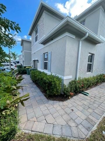 view of side of property featuring a patio area