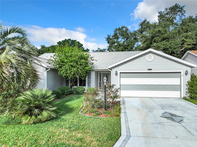 ranch-style house featuring a garage and a front lawn