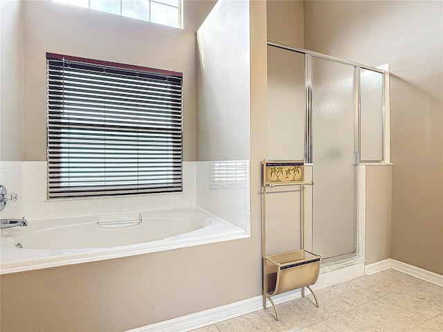 bathroom with separate shower and tub and tile patterned flooring