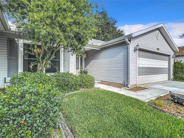 view of front of house with a garage and a front yard