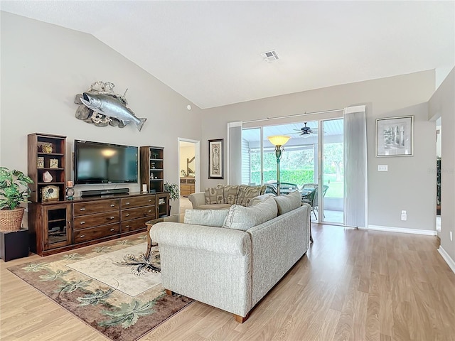 living room with lofted ceiling and light hardwood / wood-style flooring