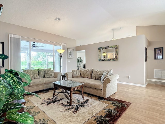 living room with ceiling fan and light hardwood / wood-style floors