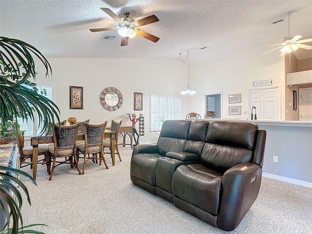 living room with high vaulted ceiling, ceiling fan with notable chandelier, light colored carpet, and a textured ceiling