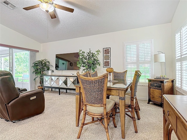 dining area featuring ceiling fan, light colored carpet, and a healthy amount of sunlight