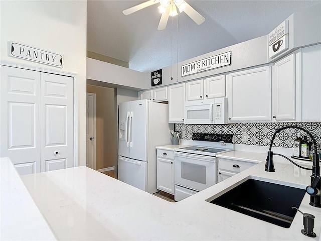 kitchen with sink, white appliances, ceiling fan, white cabinetry, and a textured ceiling