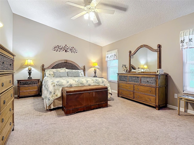 bedroom featuring lofted ceiling, a textured ceiling, and ceiling fan