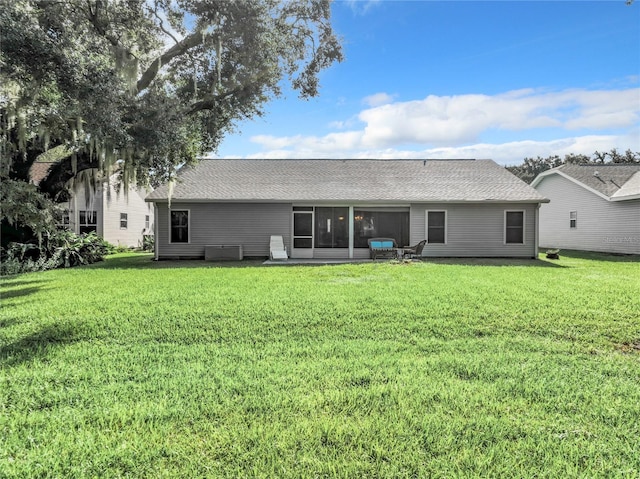 rear view of property with a yard