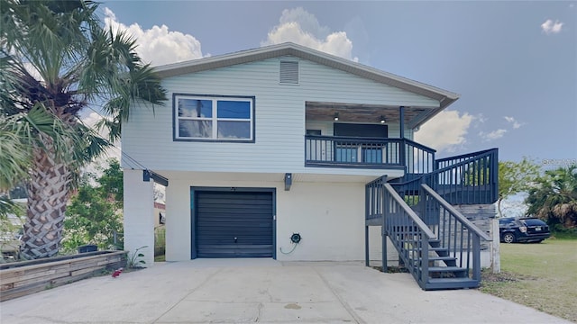 view of front of property featuring a garage and a balcony