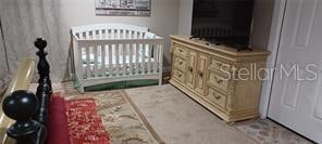 bedroom featuring a crib