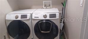 clothes washing area featuring washer and clothes dryer