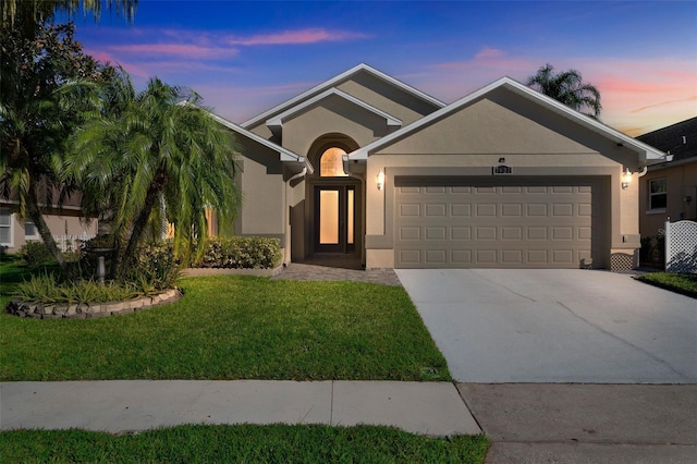 view of front of property with a lawn and a garage