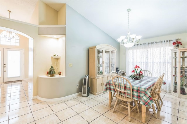 dining room featuring plenty of natural light, light tile patterned floors, a chandelier, and high vaulted ceiling