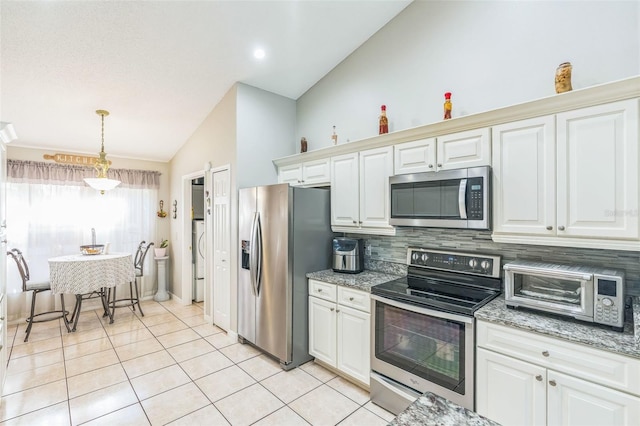 kitchen with white cabinetry, light stone counters, stainless steel appliances, and decorative light fixtures