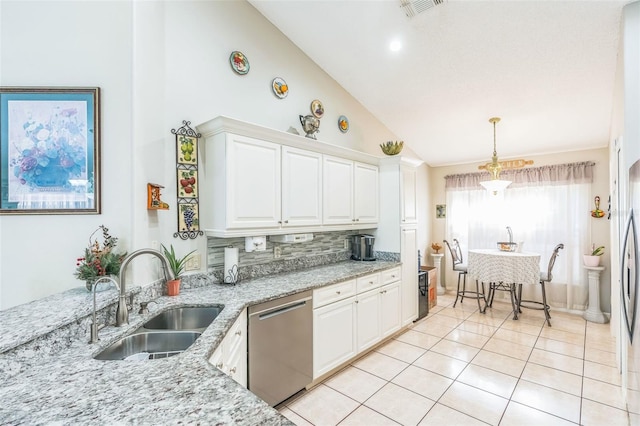 kitchen with decorative backsplash, light stone counters, stainless steel dishwasher, sink, and white cabinetry