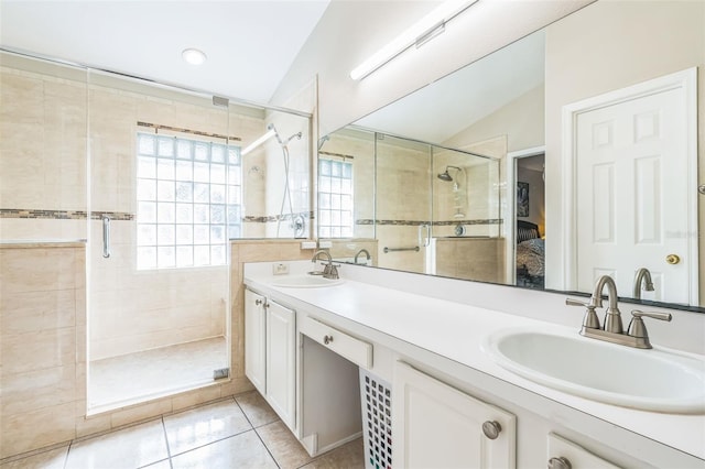 bathroom featuring tile patterned flooring, vanity, a shower with shower door, and lofted ceiling