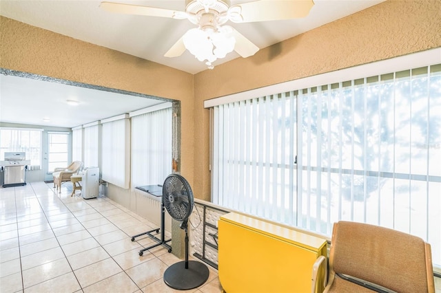 sunroom featuring ceiling fan