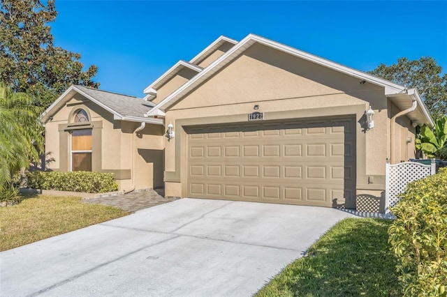 view of front of house featuring a garage and a front yard