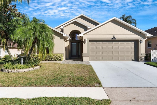 view of front of property featuring a front yard and a garage