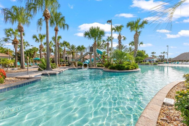 view of swimming pool with a water slide