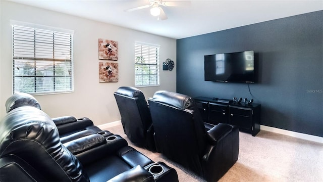 carpeted home theater room with ceiling fan