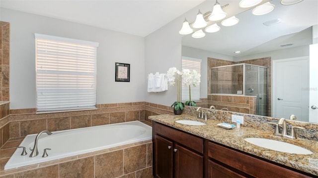 bathroom featuring vanity and shower with separate bathtub