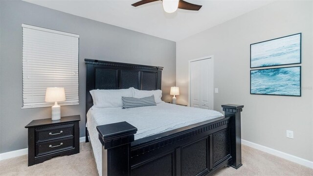 bedroom featuring light carpet and ceiling fan