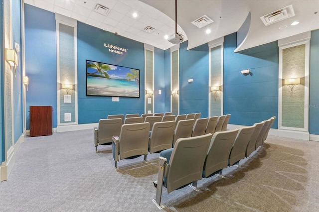 home theater room featuring a drop ceiling and carpet floors