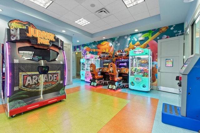 playroom with a tray ceiling and a paneled ceiling