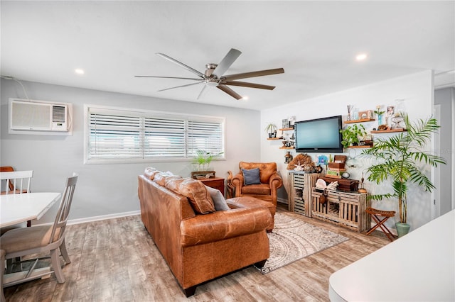 living room featuring a wall mounted AC, ceiling fan, and hardwood / wood-style flooring