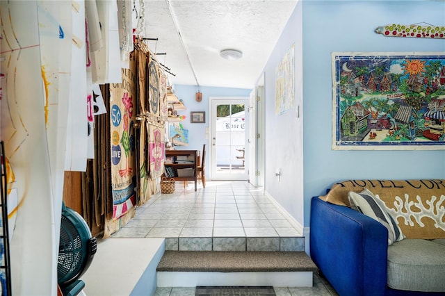 hall featuring lofted ceiling and light tile patterned floors