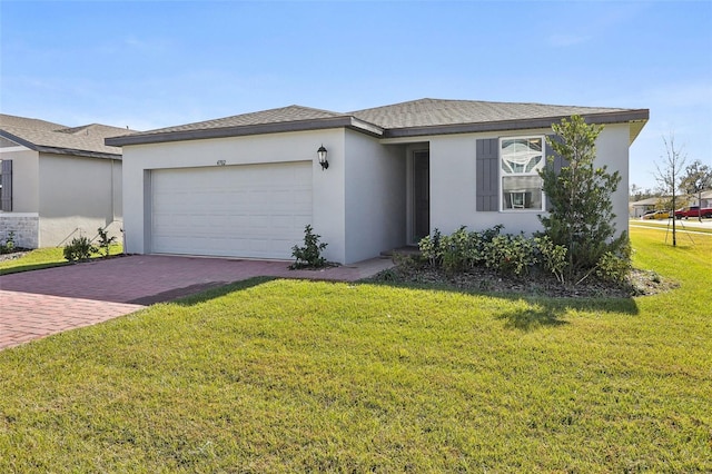 view of front of house featuring a front yard and a garage