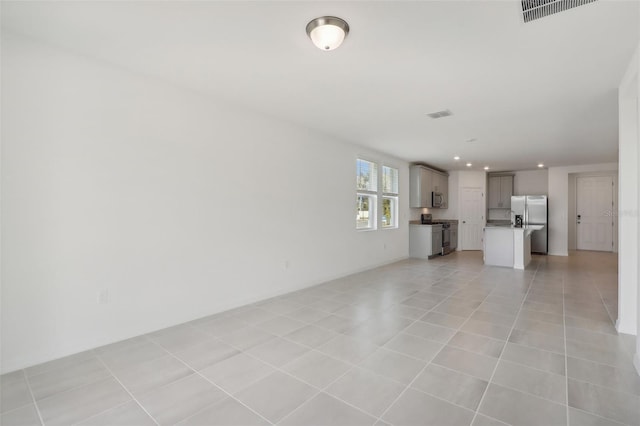 unfurnished living room with light tile patterned floors