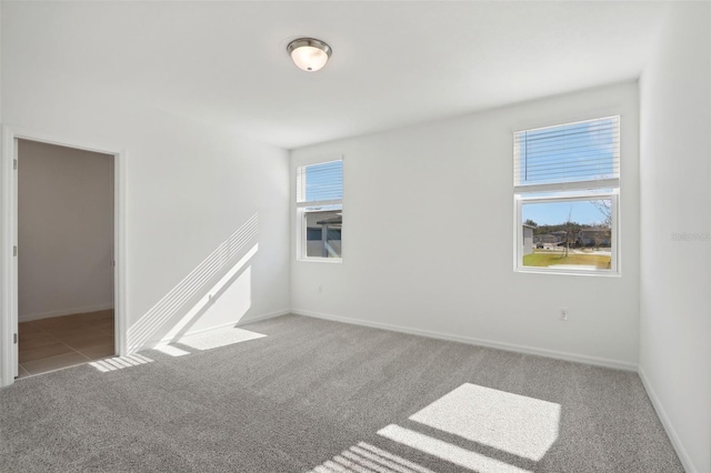 carpeted empty room featuring plenty of natural light