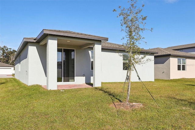 rear view of house featuring a lawn